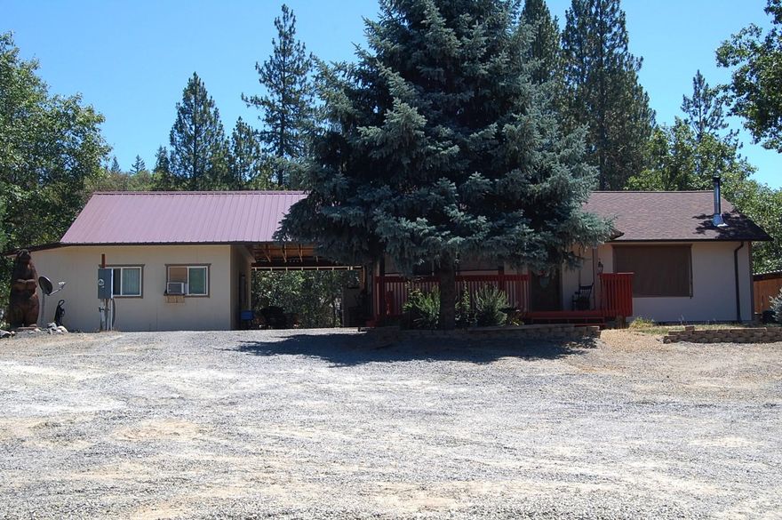 MOTIVATED SELLER! This wonderful home sits on 5.3 Acres, 2 1/2 acres are fenced and gated. The main house has 2 bedrooms, 2baths, open concept, large master with additional room off the back side, the second bedroom has access to a large storage room. The outdoor kitchen is off the dining area. The ADU is accessed through the breezeway and has accessibility features; doors, full bath with roll in shower. Workshop below, detached garage, garden area, back of property is treed with room for another shop.