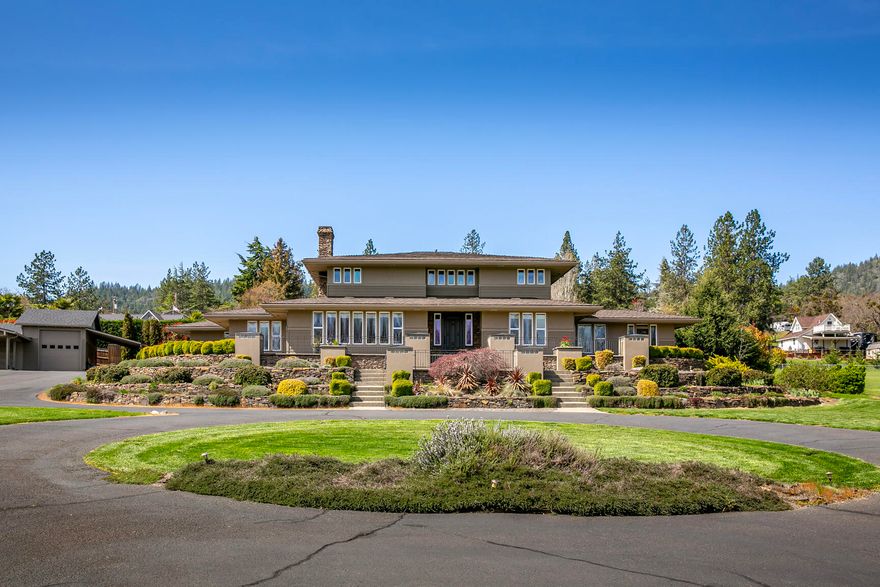 Beautiful, West Hills Estate just outside of Jacksonville with incredible views. 2 acres, completely fenced, gated and irrigated, this prairie-style home is a stunner. Natural light, hardwoods, tile, quarter saw white oak cabinetry create a rich warmth and homeyness. The kitchen has extensive built-ins and impressive pantry. Well appointed main floor Primary Bedroom with bonus room, private patio and easy access to the in-ground pool and hot tub. Lower level also features an office, laundry, formal and in-formal dining areas, living room, and more. The upper level has 2 bedrooms, a full bath and library.. Covered patio in the rear with full view of the pool area and easy access to  full exterior bath. Attached oversized 2-car garage, detached accessory building with its own 2-car garage, RV garage and attached carport for parking. 1,820 sq/ft of additional accessory space. Must tour property with a location, amenities list and style that hard to find in true Southern Oregon Estate.