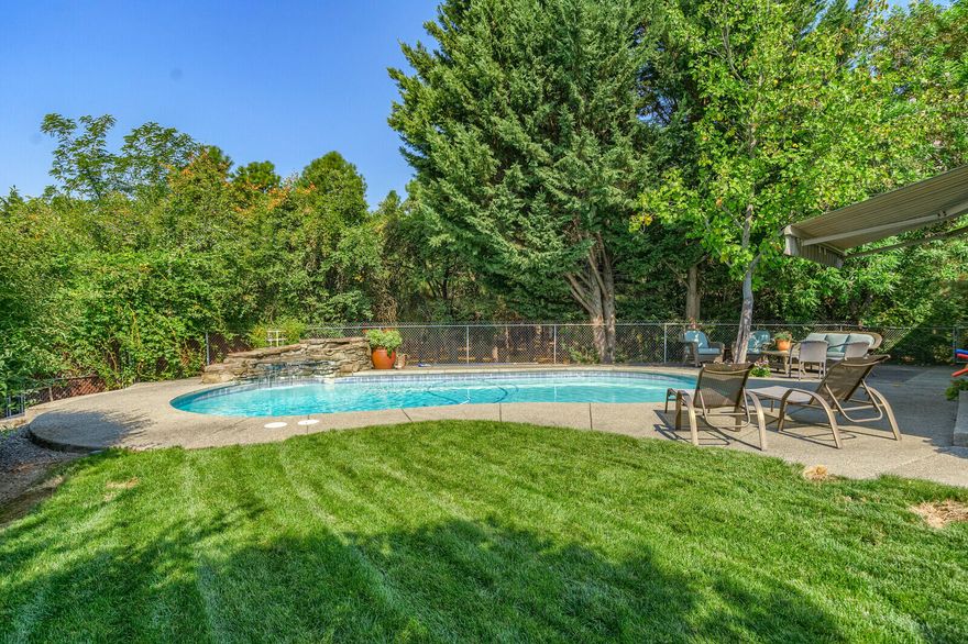 Close in & spacious 4 bedrm 3 bath home with addition & remodel in 2005-2006.  Comes with 2 garages, inground gunnite saltwater pool, & large .80 acre manicured grounds just minutes from Medford and walking distance to the mighty Rogue River.  Plenty of RV & toy parking here as you pull into your upscale gated entry. Gleaming cherry wood floors, vaulted ceilings & skylights & large peninsula style kitchen is a cooks dream. Eat-in kitchen area features banquette plus family room has roomy dining area overlooking pool and patio.. Wonderful master suite  and storage plus throughout the home.  All appliances stay, and outdoor living features private patio and large backyard deck surrounded by neighboring  trees. Natural gas heat, high speed spectrum internet, ring cameras stay.