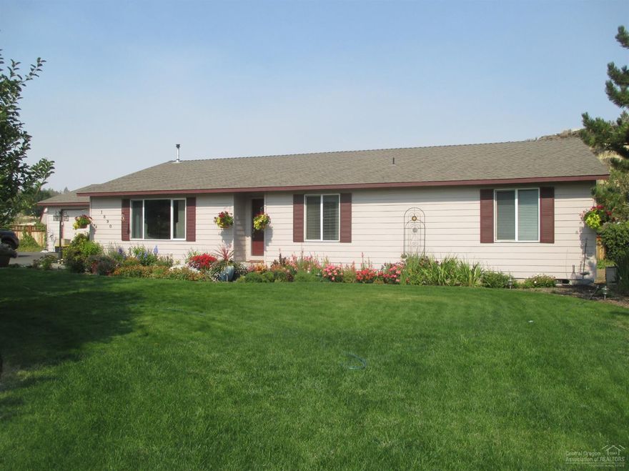 Ready for you now.Open floor plan with pellet stove to save on electricity in the winter. Upgraded kitchen with dining area and breakfast bar, vaulted ceilings. Newer dishwasher and stove. Pantry, large laundry room. Big bedrooms with laminate flooring throughout except the master bedroom. Ceiling fans, slider to covered patio. Landscaped with fruit trees, flowers and a greenhouse.Fenced and cross fenced for your animals. Three nice sheds and small barn. Get this one before it disappears.