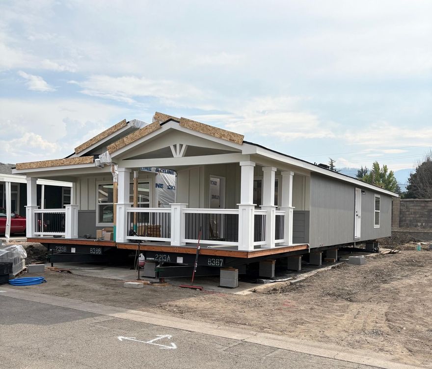 SCORE big with this new 2025 Skyline home in the sought-after Creekside Estates 55+, Fire Wise Certified community—where only a few spaces remain! This 2-bedroom, 2 bath PLUS office/bonus room home is packed with upgrades, from a kitchen featuring abundant white cabinetry, pantry, black appliances, deep SS sink, hard surface Corian countertops throughout home, & gorgeous island. You'll love the upscale vinyl plank flooring, comfy bedroom carpeting and sleek black hardware throughout. Spacious primary bedroom, gorgeous primary bathroom with dual sinks and large tiled shower. Light and bright with tons of Low-E windows, plus an 8x8 storage shed at the end of the covered carport. Creekside Estates offers resort-style living with a new clubhouse, full kitchen, fitness center, pool, billiards, and even an on-site salon. Don't wait—this favorite floor plan with beautiful front deck views won't last long!