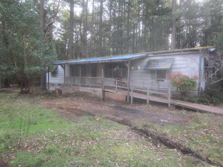 Older doublewide manufactured home on 5 flat acres with a detached 2 car garage. This is a Fannie Mae HomePath property.