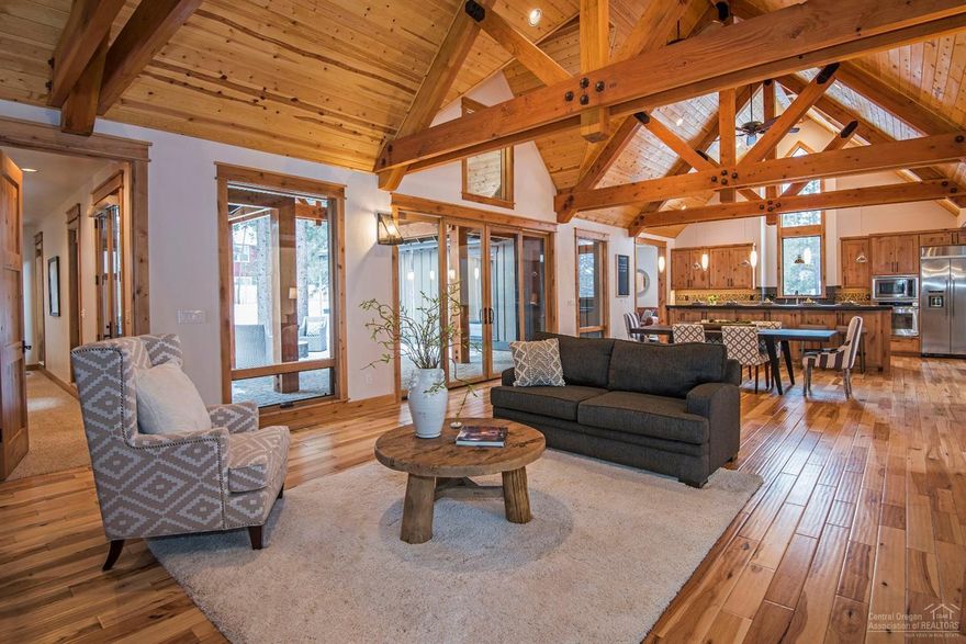 Exceptional Find, nearly new custom home located on large .84 acre forested lot in The Parks at Broken Top. This home features open great room with real stone floor to ceiling fireplace, large wood beams and hardwood floors. Chef's kitchen, large island with raised counter seats four, granite countertops, and built in Dacor stainless steel refrigerator. Main floor also includes wing with 2 bedrooms, bath and sitting room. Separate wing with master bedroom, bath features tub and separate tiled shower with heated tile floors. Large entry, utility room and powder room complete main level. Lots of large windows and slider to patio provides abundant light and views of the forest. Downstairs is family room full bath, and entry to storage in basement area. Awesome covered paver patio with gas fire pit, detached 3 car heated garage with shop area and ADU unit above. Walk to the community pool, parks, nearby access to the Deschutes River and all the westside has to offer.