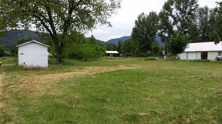 Level building site with well, septic, older garage/shop & GPID. Build or place a manufactured home on this great, close-in site. Paved driveway in to property. Located across Lower River Rd from Schaefers Lane. May require flood insurance.