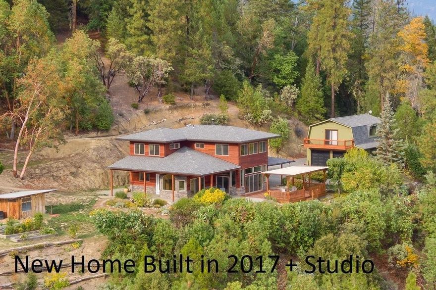 Applegate Valley w/ a new home built in 2017 + Studio. Contemporary Craftsman built w/ amenities that will last & energy efficient that will save you money! Tongue & grove Redwood siding w/ stacked stone exterior w/ lg over hangs. Lg covered patios to enjoy the beautiful forever views of the Mts, valley, landscaping & lg Koi pond w/ waterfall. Elec gated entry up on a hillside w/ lg trees & privacy. Beautiful open kitchen w/ granite counters, stainless steel appliances incl 5 burner cook top, convc. oven, white custom cabinets w/ under mount lighting & windows above to take in the views. 8' granite island w/eating bar, lg walk in pantry + work station. Hardwood & tile floors throughout. Lg windows make home light & bright. 3 bdrms, 2.5 baths. Master ste w/2 closets, sitting area, soaking tub w/ glass tile & separate shower. 2 Car garage w/ 700 sq ft studio above w/full bath & mini kitchen, balcony w/views. Radiant heated floors, ductless HVAC system, fruit trees, solar electric & more!