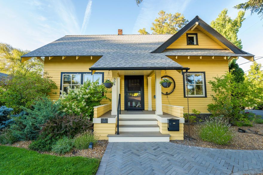 Step into the rich history of Bend with this 1920s Pacific Northwest Craftsman offering a unique blend of classic architecture and modern comfort.  As you approach, you'll be captivated by the stunning gables and corbeled roof, with a timeless style. The lush landscaping and herringbone pathway lead you to the front entrance.  The moment you step through the door, original hardwood flooring welcomes you. This home has retained its historic charm while seamlessly incorporating modern amenities. Soapstone countertops in the kitchen are a testament to this perfect blend.  With 2011 sqft of living space, main-level bedroom, New Central AC, New Furnace, HVAC duct cleaning 2023, New Roof on house and garage, Updated electric, Updated plumbing throughout, Rare downtown full-size two-car garage and  driveway, Large corner lot and walking distance to Downtown Bend, Drake Park, the Old Mill District, and the Deschutes River.
