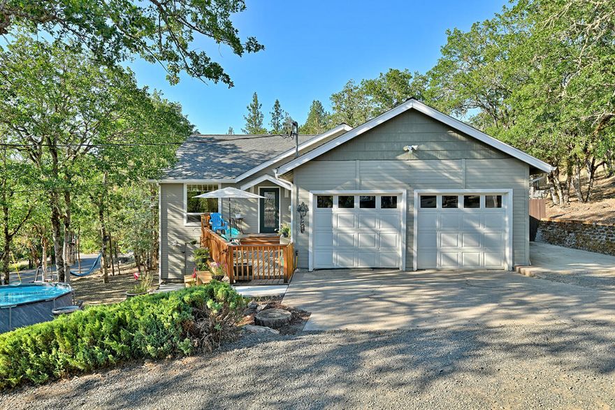 Tucked in a peaceful wooded setting, this updated 4-bedroom, 2-bathroom home offers a spacious, light-filled open floor plan. The chef's kitchen boasts concrete countertops, an island with seating, a large pantry, and newer stainless steel appliances. Elegant tile floors and wood laminate throughout the living areas offer both style and durability. The split floor plan ensures privacy, with a master suite featuring a walk-in closet. Carpets in the bedrooms and Mediterranean-inspired fixtures add character and charm. Thoughtful lighting and dimmers create the perfect ambiance. Step outside to enjoy the tranquil surroundings and abundant wildlife, good size deck, and above ground pool has been removed. This home a true retreat where modern updates blend seamlessly with nature's beauty. Note: There is an approx. 400 sq. ft. man cave, or storage room below the house with 6 feet ceilings, great space for most anything!!