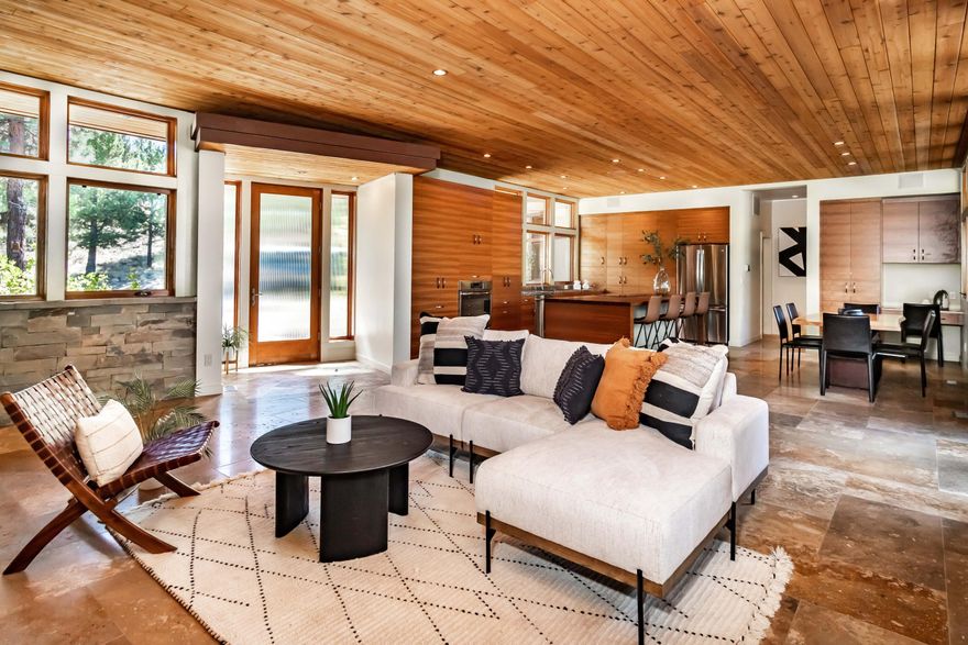 NEW PRICE! A peaceful place to call home. Nestled w/in nature's beauty, this 3 bdrm (+ office), 3 bath single lvl home located in the coveted, gated community of North Rim in NW Bend, optimizes on the desire of bringing life into a natural balance. The clever architectural design allows this prairie-style home to experience the benefits of energy-efficient living via passive solar.  The open concept floor plan allows the great room to wrap around a tranquil rear crtyrd w/ beautiful shade plantings, BBQ & hot tub; perfect for outdoor meals. Guest-smart function w/  a 'guest wing' & an 'owner's wing.'   Sleek SS counters +  huge butcher block central island beckons family/friends to gather around, sharing stories & flavors. Gorgeous walnut built-ins for abundant storage.  Guest room w/ custom Murphy bed, a light-filled crnr office. Two en-suites, 3 car garage + storage. Mtn. Modern like the town of Bend itself.