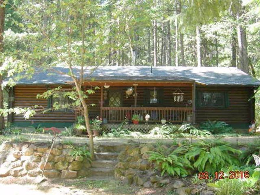 Privacy, acreage, marketable timber, desirable neighborhood and a Log Home to make it your perfect getaway. This home features an open floor plan with a nice large kitchen. Do you have horses? Set it up for your horses or other livestock. Are you a gardener? Than you will love the great producing well! If you are interested in opening up the view than you can take out some of the large growth. Meet with your logger and find out how much marketable timber is available to offset desired remodeling or pay down on your mortgage. Or if you prefer the privacy and enjoy the trees you can leave it as it is. You will fall in love with this log home as a retreat or as your home. Come out and smell the clean air and take a look at this great home. All information deemed accurate. Buyer to perform their own due diligence.