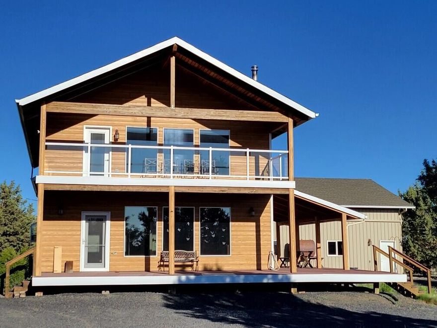 Custom built home on 5 Acres with fantastic views of the Cascades and surrounding area. This home has 3 bedrooms (Primary +1 upstairs) and 2 baths with a 3rd bathroom w/shower in Shop.  There is a huge bonus room ready to be finished that is adjacent to the primary bedroom upstairs. Approx. 300 sqft room has potential for a study, workout room or office. Upper level overlooks the living area and also offers views through the large windows with power shades. The kitchen has copper countertops and is located on the lower level along with living room, 2nd bathroom and 3rd  bedroom. There are decks facing west on both the upper and lower levels to watch the sun set behind the Cascades. Just as custom as the house is the attached 2040 sqft garage (20x28) and shop (30x40) with (4) 14' doors and are insulated & heated and include a 3rd bathroom w/shower and an additional hobby room of approx. 125 sqft. Several outbuildings for firewood, equipment, animals, storage and more.