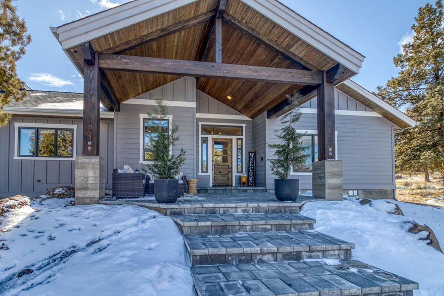 Remarkable 2.45-acre Tumalo gem that adjoins public land! Enjoy riding, hiking or wildlife viewing out your back gate! 3300+ sq. ft. custom home with beautiful open layout plus a 36x44 shop. Fall in love with the wood burning fireplace, timber beam and ship-lap accents that capture a true Northwest vibe with a stroke of farmhouse feel.  Quartz countertops, apron front sink, custom built local cabinets and vent hood. Abundant storage in the butler's pantry with 2nd refrigerator. The primary bathroom has an oversized tile shower with dual heads. Enjoy entertaining outside with a natural firepit, hot tub and an exterior TV area under 700 sq. ft. of timber frame porch roof along with over 1100 sq. ft. of paver patios. Huge garden area with fruit trees, raised beds and irrigation. The shop has 14' tall doors to fit any RV or boat and is fully insulated with heat/AC. Space above shop and utilities prepped for future rural ADU. Full RV hookups inside and outside of shop. Fully paved driveway.