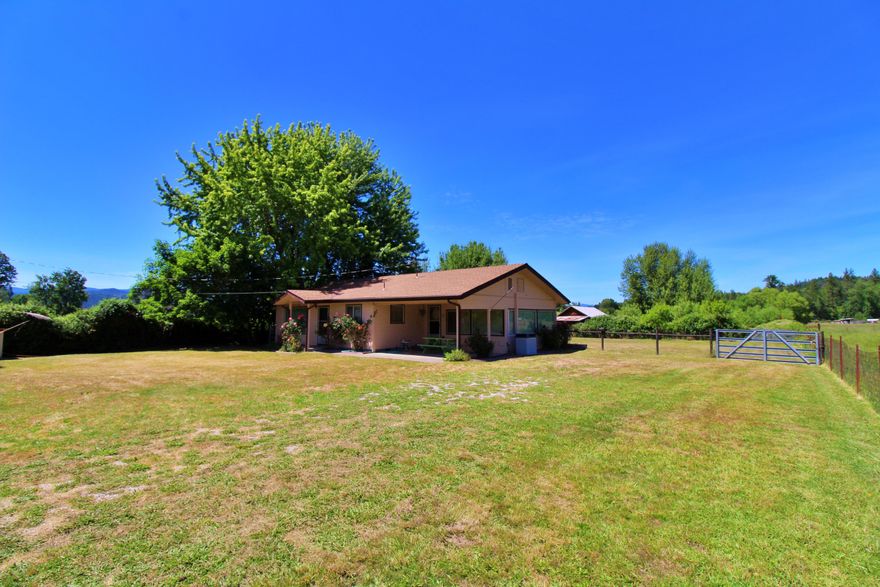 This lovely ranch style home is situated in one of the most desirable rural areas in Josephine county. This homestead property is located on a flat 5.16 acre lot with irrigated pasture, barn with livestock feeders, pond, shed, and RV hook ups. The 2 bedroom, 1 bath home has been well cared for, loved and has been a family retreat for years.  There are magnificent views of the surrounding mountains. farm land on all sides which offers the freshness of unpolluted air and the sounds and sights of wildlife all around you.  If you are looking for a place to raise livestock, grow your vegetable garden, board horses or just ride your own - come take a look today.  
All information deemed accurate, but not verified. Buyer to do own due diligence into subject property.