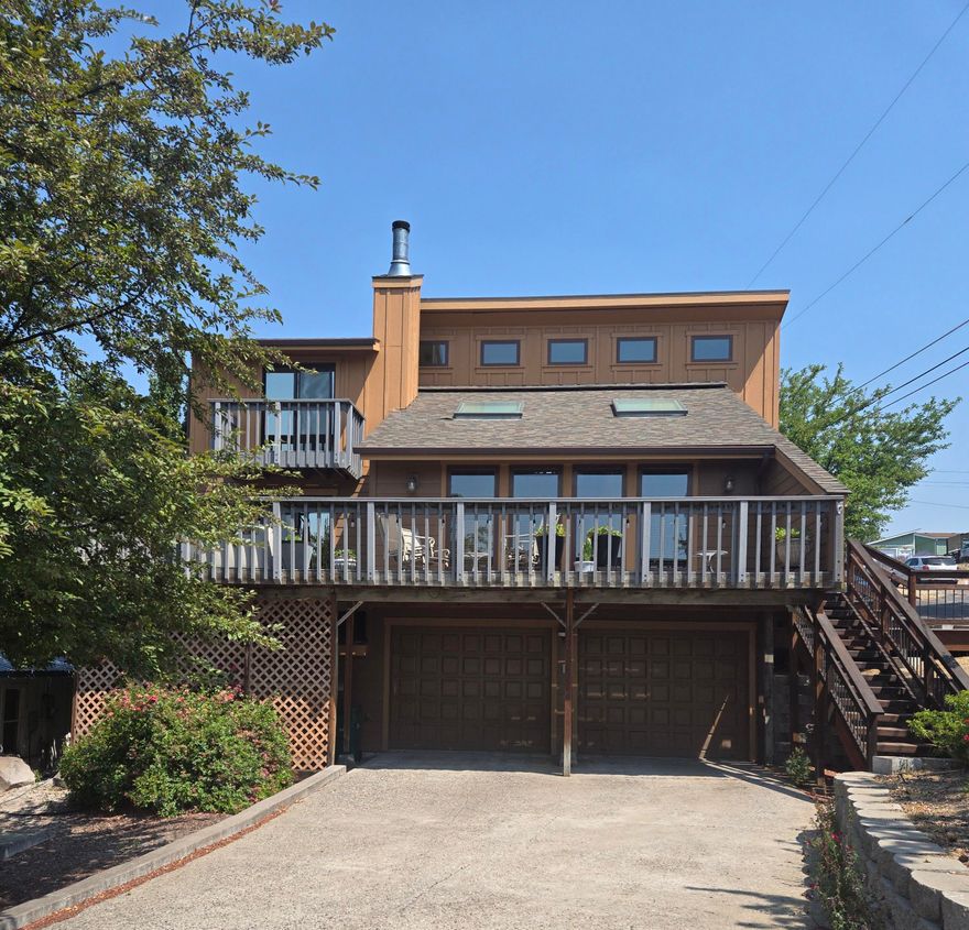 HOT SPRINGS HOME.  UNIQUE HOME with blue pine wood interior.  VIEW,VIEW,VIEW of the mountains, mount shasta, city lights, etc. This four bedroom (or 3 bedroom with a family room)  2 bathroom has GEOTHERMAL HEAT and air conditioning., wood fireplace, 5 skyslights in the vaulted ceiling.  Lots of remodeling to include Quartz counters, tile flooring, three trex decks with 1 covered. Home sits on a corner lot that is all fenced with also a living fence, to include beautiful landscaping with lots of perennials, small pond, bushes, a vegetable garden area., and has sprinkler and a drip  system. Newer roof and concrete siding.  A 20 x 10 barn with 30 amp and RV set up., also a garden shed.  Property takes up a half a block. A MUST SEE !
