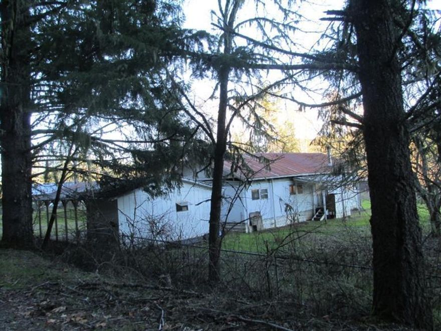 91.82 acres with over 500' of Illinois River Frontage!!! Marketable timber. Mostly hillside with some pasture next to the river. Older 2 bedroom 2 bath 1200 sq. foot double wide on level portion of property. Large old barn. Some fencing and x-fencing. Mobile is livable while building your river front home. Value is in the land.