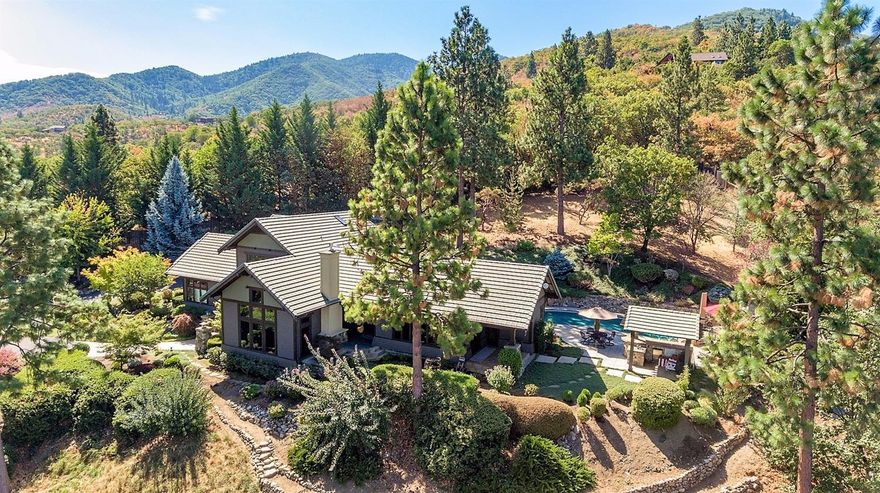 This beautiful and private gated property is located just 2 miles to Ashland's Plaza. Built in 1996, this showcase home has a fabulous floor plan & features with 3 full suites, 2 on the main level one with sauna. The interior is gracious and warm with high end materials and finish work featuring Vermont slate stone flooring, cherry cabinets, built-ins and trim, slab granite counters sophisticated, open and light design. Step down stunning living room with floor to ceiling windows, exquisite mountain views, built in cabinetry and gas fireplace. Elegant open dining room opens to spacious chef's kitchen that you will love. Large 3rd suite on upper level with extra spacious office/library. The grounds are impeccably and beautifully landscaped with extensive outdoor entertainment area with inground solar heated pool, outdoor kitchen & fireplace. Custom iron entry gate. Deer fenced. Greenhouse. Water storage building.