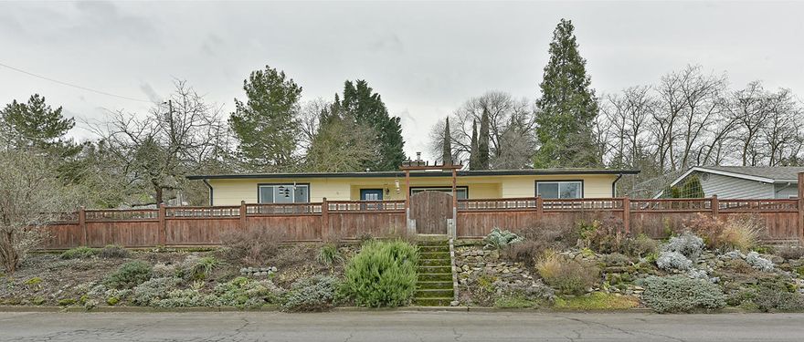 Fantastic opportunity to own a home in a lovely neighborhood! From the views to the brand new kitchen it is sure to delight! This 4 bedroom home features a large living room with amazing fireplace surround and wood burning insert. The kitchen was just completed and is a chef's dream w/concrete counters, stainless appliances and beautiful cabinetry. Master bedroom is huge, features an on-suite bathroom, French doors to the stone patio & has a lovely view of Roxy Ann. There are 3 additional guest bedrooms and beautiful newly remodeled guest bathroom. The laundry room is large and has a nice sized pantry for all of your goodies. From the front porch you can relax and enjoy views of the surrounding foothills after a long day. The covered carport is enormous and there is additional parking for a large RV. There is also a workshop and additional storage room for all of you toys. This home is truly special! Call today for your own personal tour.