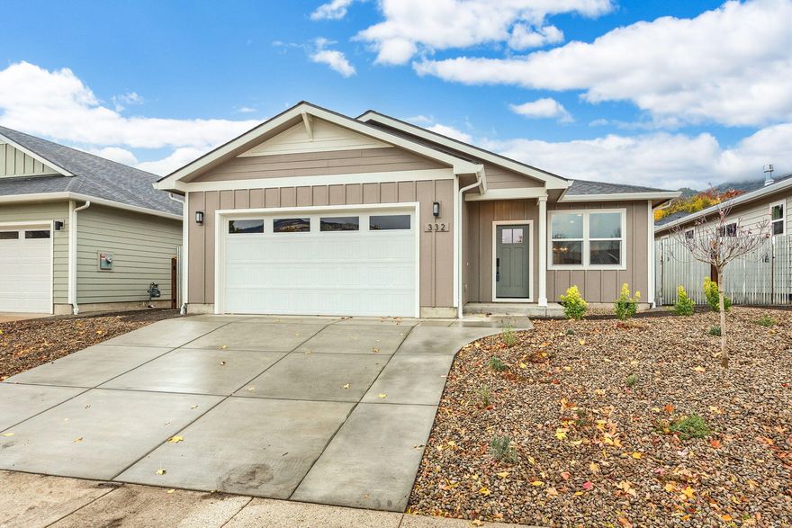 This new move-in-ready, low maintenance, comfortable, single level home built by Taylored Elements Construction just .8 of a mile from downtown Ashland. This 3 bedroom, 2 bathroom has a gas fireplace in the living room with built in shelving, lots of windows for abundant natural light, engineered hardwood floors in main living areas, carpet in bedrooms, tile floors in bathroom and laundry room, quartz countertops and custom cabinets with soft close drawers. The spacious kitchen has a farmhouse sink, stainless appliances and door to back patio. The primary suite has a walk-in closet, walk-in tile shower, dual vanity and water closet. It's built to Earth Advantage standards with green features and energy efficiency including solar panels, EV charger in the finished 2 car garage and ductless heating and cooling system. The yard is fully landscaped with drip irrigation and side to back yard 6 foot fencing. The last home of this size in West Village - Don't miss it!