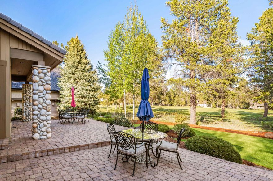 Beautiful lodge style home on the Woodlands golf course! High end wood accents throughout give this home a warm, Sunriver feel. Main level living w/ primary suite on the main level. Spacious open floor plan includes vaulted wood ceilings and floor to ceiling rock/wood fireplace in the great room. Gourmet kitchen w/ granite counters, chiseled granite sink, high end appliances, gas cooktop and wet bar w/ beverage and large wine refrigerator. Beautifully landscaped outdoor space w/ hot tub, built in BBQ and paver patio overlooking the golf course. Additional features include steam shower, humidifier, heated garage and much more. This home is quality throughout. Sold furnished and ready for you to enjoy. Start making memories in this Sunriver home!