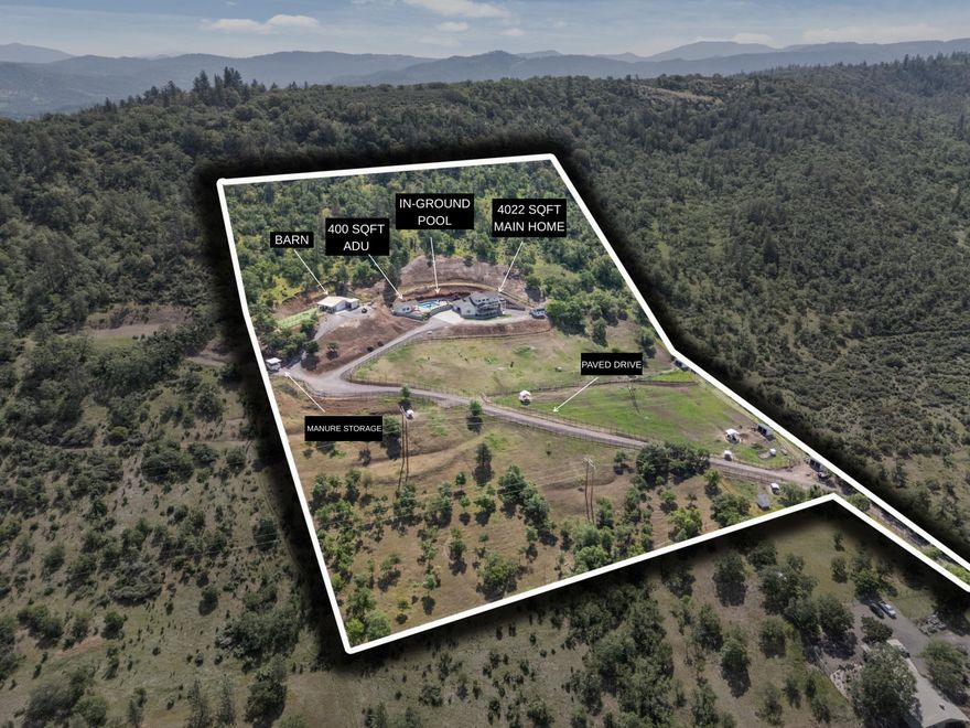 VIEWS VIEWS VIEWS! This private, gated East Medford home offers 4,022 sqft of main home living with breathtaking sunsets and panoramic vistas. The 3-bed, 4-bath with additional office layout is an entertainer's dream. A large balcony and spacious covered patio offer room for entertaining. The 2-car garage and additional RV garage feature vaulted ceilings for abundant storage options. Inside, discover elegant hardwood floors, tray ceilings, and a chef's kitchen with pantry, double ovens, and stainless-steel appliances. The owner's suite is a sanctuary with huge west-facing windows showcasing stunning Rogue Valley views, a private balcony, climate control, hot tub, large fireplace, sauna, and built-in wall safe. Step outside to find a swimming pool with large island, 2 fire pits, plus separate 400 sqft 1 bed, 1 full bath ADU, a barn, spacious workshop, and multiple sheds. Fenced and cross-fenced, making it turnkey for livestock or horses. The land is also fire defensible space managed.