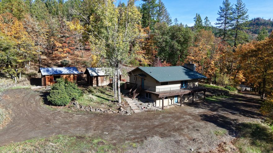 Freshly remodeled 3-bedroom, 2-bath home featuring 1,911-sq. ft. of spacious, open living filled with natural light! Enjoy breathtaking mountain views and abundant wildlife from every room. The home offers a new kitchen with butcher block counters, freshly updated bathrooms, laminate flooring throughout, wood-burning fireplace, expansive decking, durable metal roof, and new mini splits for year-round comfort. Plenty of room for all your toys, projects, and hobbies on 21.51-private acres. The property backs up to over 2,500-acres of public lands, providing endless opportunities for hunting, trail riding, hiking, and outdoor recreation in every season. Just 7 minutes from Shady Cove, this home combines privacy, comfort, and adventure, making it a true nature lover's paradise where every day feels like a getaway.