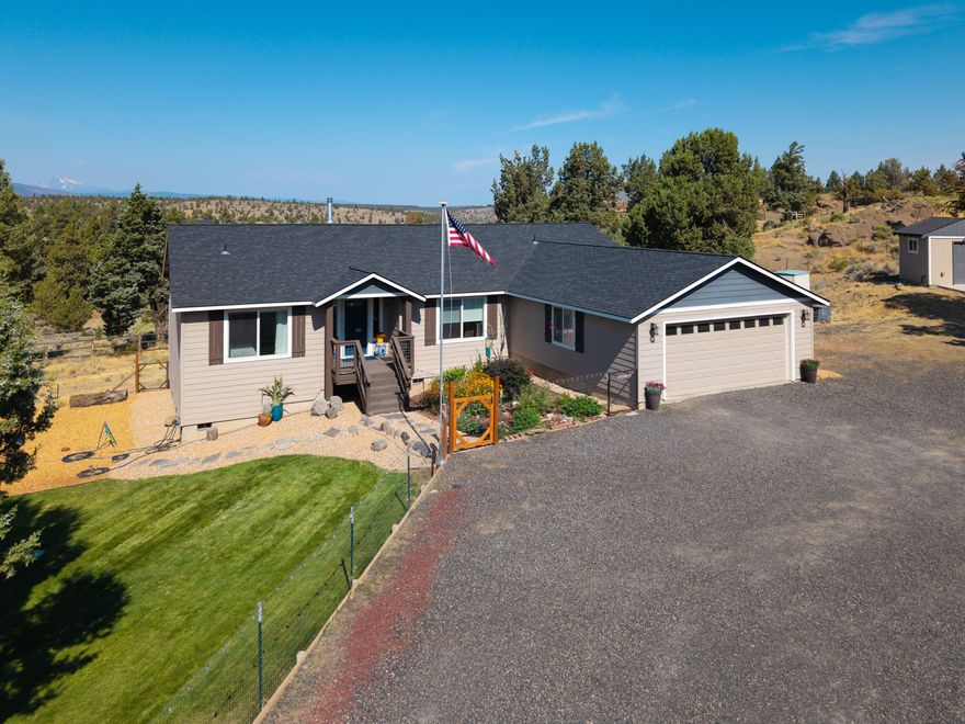 Highly upgraded single level home on over 2 acres w/a great room layout, unobstructed Mt Jefferson views, a shop, & insulated/finished hobby shed. Upon entering the home, you are greeted by vaulted ceilings in a great room space that separates the primary suite from both guest bedrooms while offering high end LVP flooring, a kitchen island, quartz counters, 2 pantries, & direct access to the large deck w/pergola. The primary suite has expansive built-ins, a slider to the deck, spacious walk-in closet & a double vanity bath w/soaker tub & stall shower. Both guest bedrooms are large enough for king-size beds & share a well laid out bath w/tub shower combination. The shop has a covered RV area, & the inside has ample space for all your storage & hobby needs. A detached & fully insulated hobby shed has AC, a covered porch, & attic storage & the well house has a generator hookup for the well along w/a shower/sink. Below the property there is quick access to the Deschutes & Steelhead Falls!