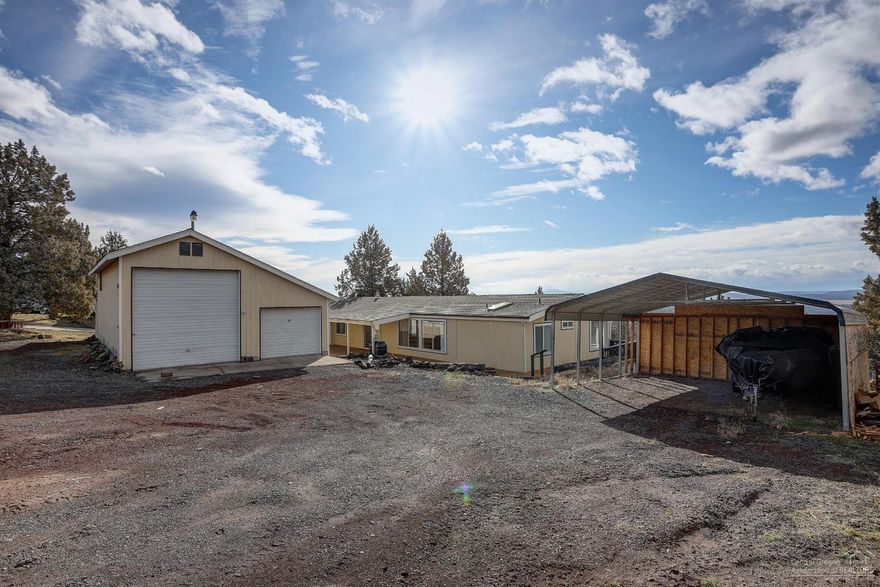Move in ready home with incredible views nestled in the heart of Crooked River Ranch! Just under 1 acre situated on top of the hill lends to incredible Cascade Range Mountain Views and plenty of room for your vehicles and toys! With a 26'X38' Shop w/ Bonus Room & Office, Oversized Carport, additional storage sheds, and room to build more storage - this is an ideal home for recreational vehicle enthusiast! This home offers 3 spacious bedrooms all on one level, master suite separation and a large covered deck and big windows to soak in the beauty of Central Oregon! Kitchen offers an open concept w/ island and ample cabinet and counter space for cooking and hosting guest! This home is equipped with a high efficiency pellet stove and A/C system to keep you at a comfortable temperature year round! Come and enjoy the features and amenities that come with be being an home owner in Crooked River Ranch!