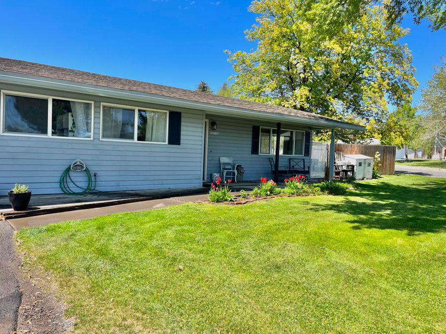 The garden enthusiasts' home awaits.  Don't miss out on this opportunity to own a rare, 3 bedroom 1 bathroom home, in a gated community. Situated on a quiet, large corner lot, this home has an exceptional backyard functional for entertaining, gardening and enjoyment. The established fruit trees, raspberry bushes, large strawberry patch will provide fresh fruit for years.  Full garden waiting for harvest. Extra-large concrete patio with a nice pergola. A large parking area in the back, leaving plenty of yard to enjoy. Large storage shed & covering outside.  Home is hot tub ready, with hook ups. home has fresh paint throughout, as well as many updates. The kitchen completely remodeled, to add more counter space & storage. Garage has been converted to an additional room that can be used for whatever your needs are. The HOA provides a secure gate, front lawn maintenance, snow removal, sewer, water, trash and roof repair/replacement. Enjoy the private park, community center and RV storage