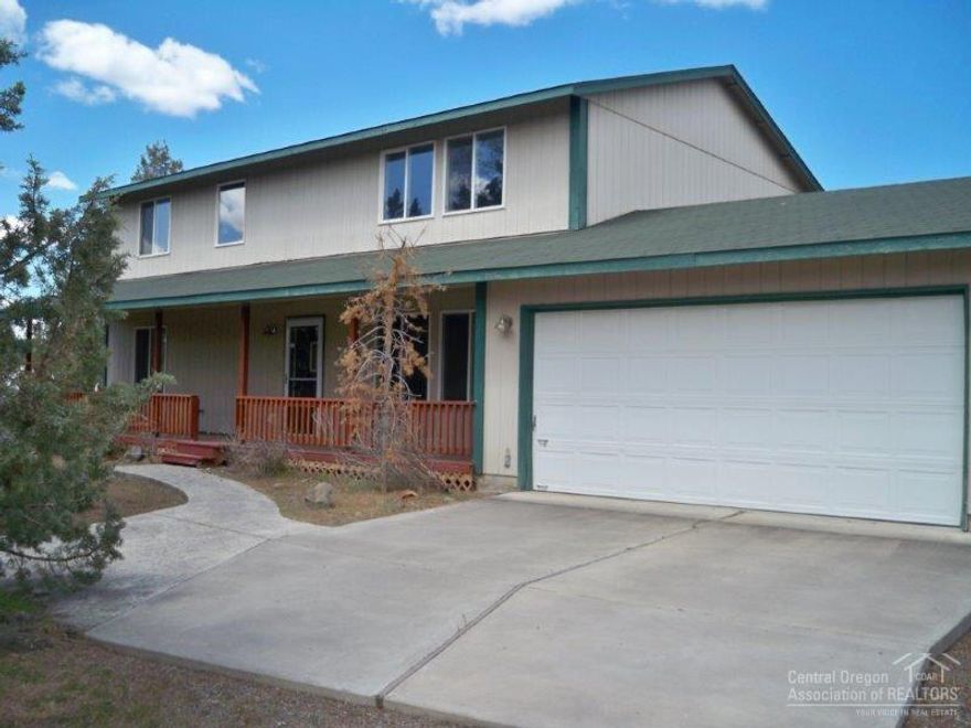 Quiet country home on a large 3.3 acre lot close to town. 3-bedrooms, 2.5 baths with 2080 sq. ft. of living area. Laminate wood flooring in living room and dining areas. Covered front porch, fenced. Bonus room for office. Large detached 36x48 garage shop, greenhouse and much more. Room for RV's. Paved streets.
