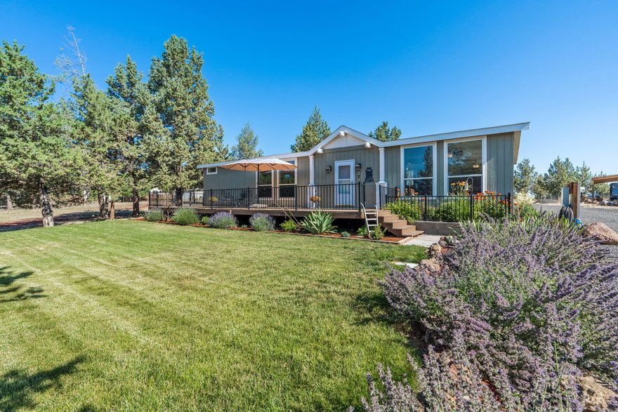 This home is truly a gem located on the Crooked River Ranch.  It is in immaculate condition.  You will never feel like you are in a manufactured home once you walk through the door.  The 8.5ft ceilings gives you a feeling of many more square feet of living space.  The open floorplan of 1680sf features 3 bedrooms (one bedroom could be an office) and 2 full bathrooms, new high end LVP flooring and carpet throughout, a large kitchen with Alder cupboards, breakfast bar, and laminate counters.  The very large windows in the living area allow for natural light in and beautiful views of nature.  Primary bedroom has walk in closet, double vanities, linen closet and shower stall.  There is a 2 car garage which includes shelving as well as a work bench.  The property also has 2 RV hook-ups, (30 or 50 amp) water and a septic dump, dog kennel and a shed for additional storage. The large front deck is a great way to share the quiet peacefulness and beauty of living on the Ranch while entertaining.