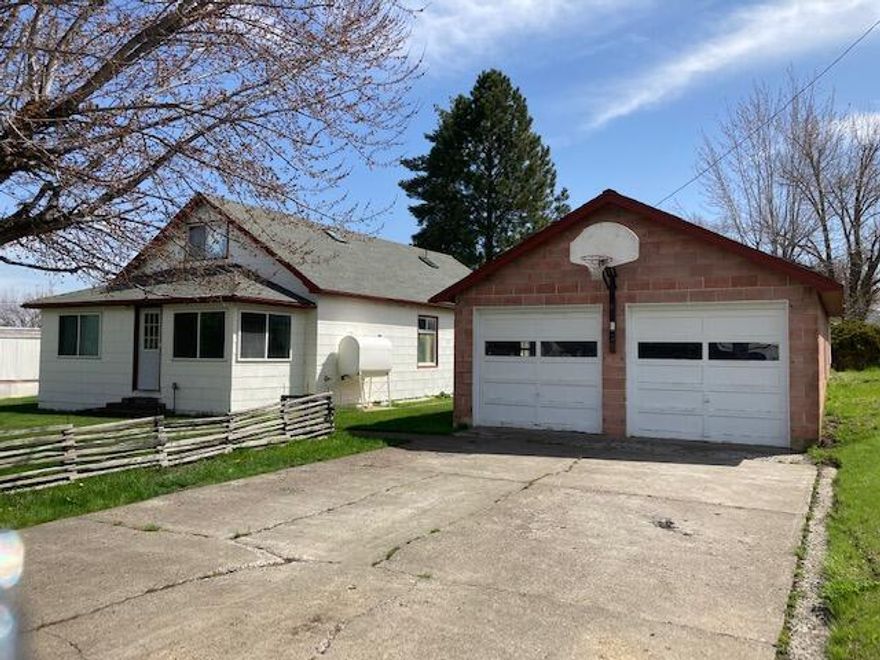 Nice Family Home On Quiet Street In Long Creek! Large corner lot with mt views, 2 story, open floor plan w/wood accents, living room, kitchen w/breakfast bar & appliances, dining room, utility room w/storage, cold storage/cellar, 4 bedroom, bonus room, 2 bath, lots of storage, enclosed front porch w/window storage/seating, oil monitor, baseboard and heat pump w/ac, ceiling fans, vinyl windows w/blinds, carpet & vinyl flooring, composition roof, landscaped, frost free faucets,  sidewalks, pine trees, detached double car garage w/large cement apron & workshop area, 3 nice outbuildings, wood storage area, slate rock patio fire pit area, plenty of parking, 2 tax lots.  $229,900 #1112