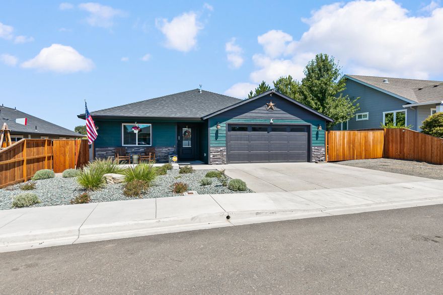 Welcome to this stunning 2023 Travis Snyder-built home in the desirable Eagle Point neighborhood! Immaculately maintained, this 4-bedroom, 2-bath gem boasts a spacious open floor plan, rich brown-stained cabinetry, granite countertops, and upgraded blinds and window coverings throughout. The laundry room features built-in cabinetry, and both front and backyards offer low-maintenance landscaping. Out back, enjoy a covered deck with gas plumbed for the included Blackstone griddle, plus a pebble rock area currently used as a dog run. The large, deep RV parking includes a sewer clean-out and power—perfect for your toys, trailer, or guests. Every detail was thoughtfully chosen, and it shows. Just minutes from town, shopping, the Rogue River, and nearby lakes, this home still looks, feels, and smells brand new. Schedule your showing today!