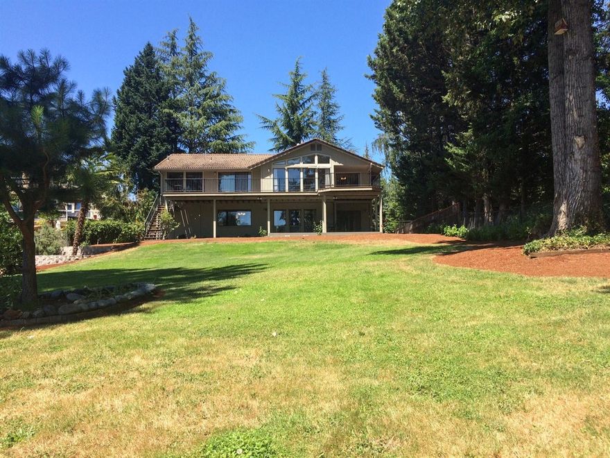 Easy living on the Rogue River! This custom built family home has the rolling green grass to the river's edge everyone desires. Located on a city cul de sac, close to all services but tucked away, you will love the setting and the accessibility to the river. Large open glassed entry and wood floors throughout make this 3768 sq foot home feel very comfortable and homey. South facing with large windows throughout. There are 2 bedrooms downstairs as well as a family room with a Jotul gas stove. Upstairs you will find the formal living room, formal dining, open kitchen and sitting area overlooking the decks and river beyond, as well as the Master suite and a guest bedroom. Tile roof. New Heat Pump for heating and cooling.