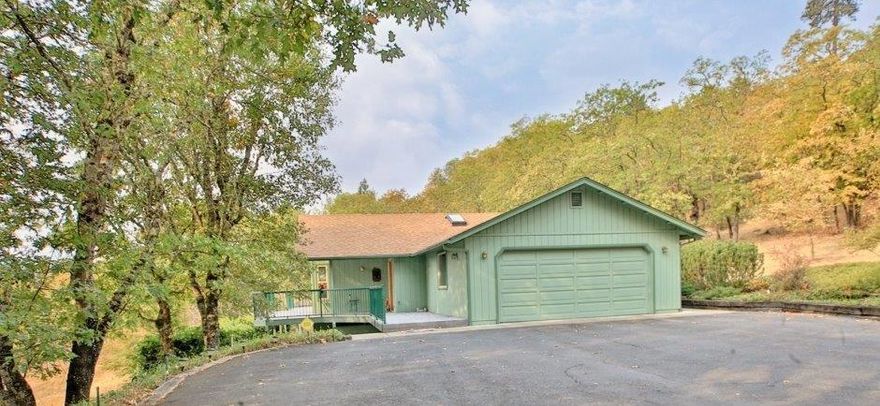 Beautiful Mountain Views! A paved driveway invites you to this 3 bedroom, 2 bathroom, 1786 sq. ft., 1998 blt. Home is clean and very well cared for! Large deck offers great outside entertaining space or some peacefulness! Hardwood floor entrance welcomes you into the luxurious living room with large windows taking in the mountain ranges. Formal dining area next to spacious kitchen with beautiful Oak cabinetry, skylight & large island with eating bar for extra counter space! A fabulous walk in pantry for all your goodies! Breakfast nook area is open to kitchen with bay window, laundry room with sink is just off from kitchen. Main bathroom has skylight, Master bedroom is large with two closets and a sliding door to access deck. Lush shrubs and trees surround this meticulously cared for home with sprinkler & drip system. Two car attached garage, two car detached garage and a two car detached garage with shop finished & insulated! 30 yr. roof put on in 2013, heat pump replaced in 2015.