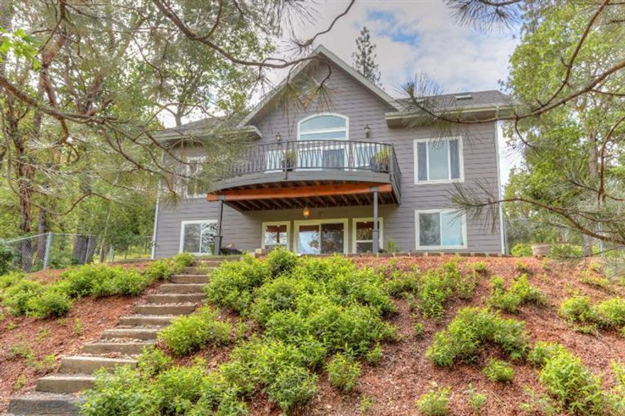 Welcome home to your own private oasis in the Applegate Valley. Nestled among 5 acres of woodlands, this stunning property boasts a 3 BR 2.5 BA, 2184 SF custom home w/an additional, over-sized 2-car detached garage, 481 SF finished bonus room (unheated) & 720 SF shop/RV garage. As you enter the home, immediately bask in the gorgeous forest views highlighted by the large windows throughout the open floorplan. Enjoy a main level master suite w/ walk-in closet & luxurious master bath w/a drop in tub, walk-in shower + a double sink vanity. The gorgeous kitchen, dining room, family room & powder room are also on the main level. On the lower level of the home, you'll find an amazing great room w/wet bar that opens to a cozy back patio & large fenced yard. You'll also find a small, built-in office area, laundry room, full bath & 2 additional bedrooms. Hike down to a season creek, revel in the impeccable landscaping throughout the grounds & make every day brilliant in your very own sanctua