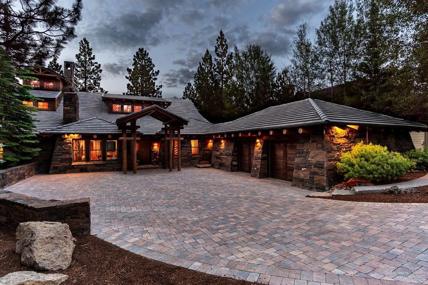 Privately tucked among the pines overlooking the 15th hole of the award winning Broken Top Club golf course, sits this beautiful custom northwest lodge home that exemplifies rustic elegance at its finest. A unique offering designed by Jeffrey L Miller and finely built by Sun Forest Construction. Natural light invites you into the expansive two-story vaulted great room with magnificent Broken Top rock floor to ceiling wood burning fireplace. This very lightly lived in home has been seamlessly improved in recent years and features a floor plan designed for entertaining and indoor/outdoor living. Main level master and study with wood burning fireplace, lookout tower loft bedroom and hideaway room on 2nd level, plus two additional bedroom suites, fully equipped theater room and wine room on the walkout lower level. Gorgeous wood and plentiful use of stone, gourmet kitchen with Thermador & Viking appliances, in-ground outdoor hot tub and oversized heated garage complete this special home.