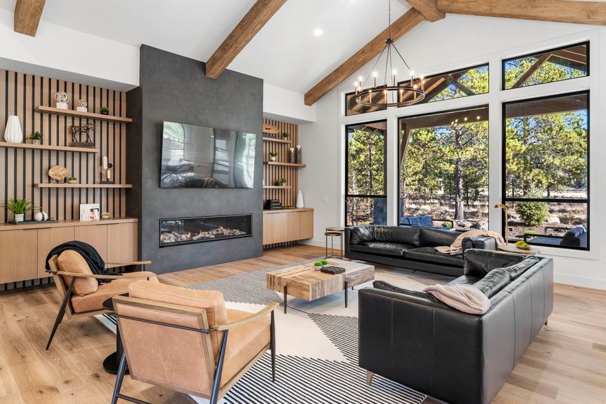 Just completed home in Caldera Springs! Come enjoy this custom mountain-modern home that offers ample gathering spaces perfect for large families, and special get-a-ways. There are three on suite bedrooms on main level along with great room, den with its own bath, gourmet kitchen with a butler's pantry, and laundry room. Upstairs find two more bedrooms plus a bonus room. Expansive covered paver patio with hot tub enclosure. Features include distress wood beams, custom cabinetry, rich woods, solid surfaces, high end appliances, and Central Vacuum with a in wall hose, built in fridge and wi-fi enabled zoned Central A/C. Sold furnished and ready for you to enjoy.