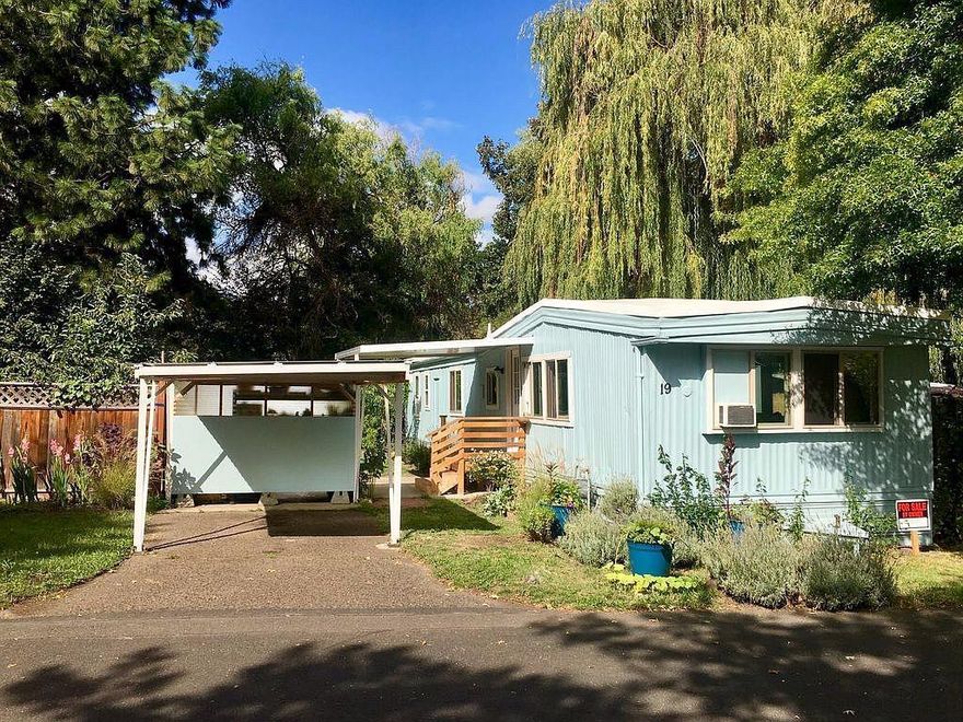 Affordable and peaceful Ashland living! Come home to rural charm and urban convenience. Your new home is nestled in true nature sanctuary with large established tress in a calm and peaceful park setting. Sitting on the edge of 4 ponds with caressing sounds of flowing, falling water, leaves in the breeze, frogs and birds. Relax outdoors and enjoy the amazing Ashland sunsets from your back deck. Beautiful views of Grizzly peak and surrounding mountains. 12ft. x 20ft. additional room/bdrm. with private entrance and sliding glass door to creekside deck. Bathroom is remodeled w/ new stackable washer/dryer. All windows are replaced with vinyl framed, double pane glass. New exterior paint and a roof. The entire place was newly winterized in 2018. Carport and front porch were rebuilt in 2017. Welcome to your low maintenance home.