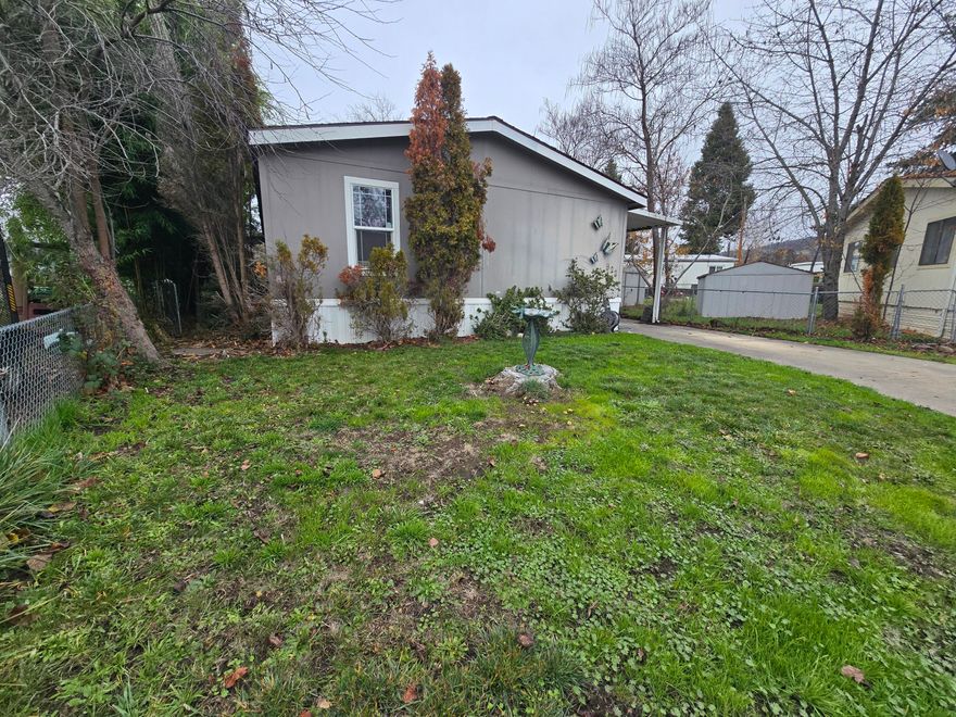 *THIS HOME IS SITUATED ON ITS OWN LAND* Welcome home! This charming 3-bedroom, 2-bath residence offers 1,512 sq ft of comfortable living and sits on its own .11-acre lot in the heart of Eagle Point. Enjoy the convenience of being close to shopping, schools, and dining while still tucked away in a peaceful neighborhood. The open layout and expansive vaulted ceilings create a bright, airy feel throughout. The kitchen offers abundant cabinetry and storage, perfect for all your cooking essentials. Relax in the spacious primary suit featuring a garden tub for soaking after a long day. A separate laundry room provides added functionality and leads out to the back porch—ideal for enjoying your morning coffee or unwinding in the evenings. This home truly combines comfort, convenience, and charm in one great package!