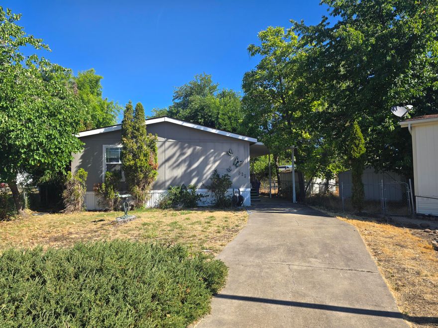 *THIS HOME IS SITUATED ON ITS OWN LAND* Welcome home! This charming 3-bedroom, 2-bath residence offers 1,512 sq ft of comfortable living and sits on its own .11-acre lot in the heart of Eagle Point. Enjoy the convenience of being close to shopping, schools, and dining while still tucked away in a peaceful neighborhood. The open layout and expansive vaulted ceilings create a bright, airy feel throughout. The kitchen offers abundant cabinetry and storage, perfect for all your cooking essentials. Relax in the spacious primary suit featuring a garden tub for soaking after a long day. A separate laundry room provides added functionality and leads out to the back porch—ideal for enjoying your morning coffee or unwinding in the evenings. This home truly combines comfort, convenience, and charm in one great package!