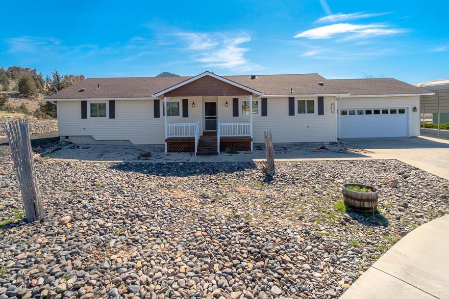 Situated high on the hill looking out to Barnes Butte & majestic rock pillars, this single level home is a rare find. Great room layout with a wall of windows that showcase the Central Or sunrise & sunsets. Open kitchen w/island & eating bar, plenty of cabinets, tile floors & all appliances included. Wide living space w/corner wood burning fireplace for efficient winter heat & cozy mornings. Master Suite offers an easterly view & the bath fts tile floors, walk in Jacuzzi shower w/seating & body sprays. Adtn 2 bedrooms & guest bath w/tub/shower. Living space opens to full length deck overlooking the valley. Spend your evenings soaking in the hot tub & enjoying the view & pleasing sounds of nature. Retractable Sunsetter awning for year round enjoyment, rain or shine! New vinyl siding, new roof & outfitted w/seller owned Sunlight Solar system for a huge power savings. 2 storage sheds are included. Bring your RV & boat - this property has a covered RV space & boat/toy storage. 1.7 acre lot