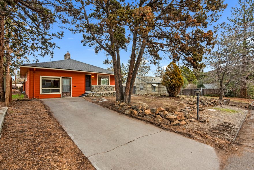 This prime Midtown location is just blocks from restaurants, shopping, Pilot Butte State Park, Juniper Swim & Fitness Center, and Juniper Park. Juniper Park amenities include a playground, a small softball field, horseshoe pits, tennis courts and forested walking trails. This three-bedroom, two-bathroom home allows for endless possibilities. The front bedroom could be an ideal home office. Most major home systems have been updated including newer roofs, solar tubes, furnace, heat pump, electrical panels, can lights, and water heater, giving you the perfect canvas for creating your dream home. There is abundant storage throughout the home. Outside, you will find a large storage shed, a hard-to-find detached oversized 840sf 3-car garage with 2 garage doors, and an additional parking space adjacent to the garage, all with alley access. Enjoy Pilot Butte views from the great room and backyard.