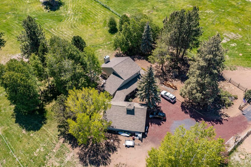 FOR COMP. Breathtaking 20 acres on Woodside Road, post and rail fenced and cross-fenced, with 17 acres of fully automated irrigation in Bend. Are you looking for your own private retreat less than 15 minutes to downtown Bend? Steps away from a private pond, this home is a desirable one-story, ranch-style, 2 bed/2 bath home with a large front porch, an extra large attached 2-car garage, an office, and a dining room. It has a heat pump and AC. This truly impressive property features an unbelievable 1850 SF shop with a full bathroom and more than enough space for your RV, farm/ranch equipment, and toys. In addition, there is an accessory building with 2 full bathrooms, a loft, and it's own garage.