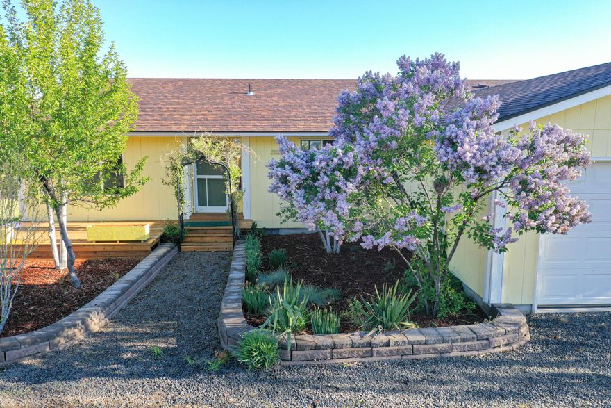 Country living and only minutes to town! This is a very clean 2002 Adair built, three bedroom, two bath home with a new roof on five acres. Beautiful new floors, newer stainless steel appliances and bonus utility room with new water heater. Washer, dryer and refrigerator included with sale. Enjoy mountain views from your nice sized deck. This home has a two car garage, RV pad with hook ups, fenced for animals and a bonus with the many mature fruit trees. Private well, two new pressure tanks and easy access makes this a home that is move in ready!