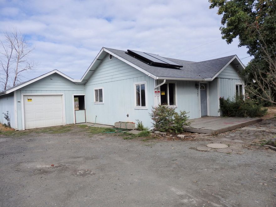 Sweet home looking for someone to bring it back to its full potential. Set on nearly a half acre, this home offers 2 bedrooms, 1 bath, ovesized 1 car garage w/shop area, covered patio and a large, fenced rear yard for play or animals. Great location near town; good floor plan with Jack & Jill bath. Call today for your personal tour, and welcome home!