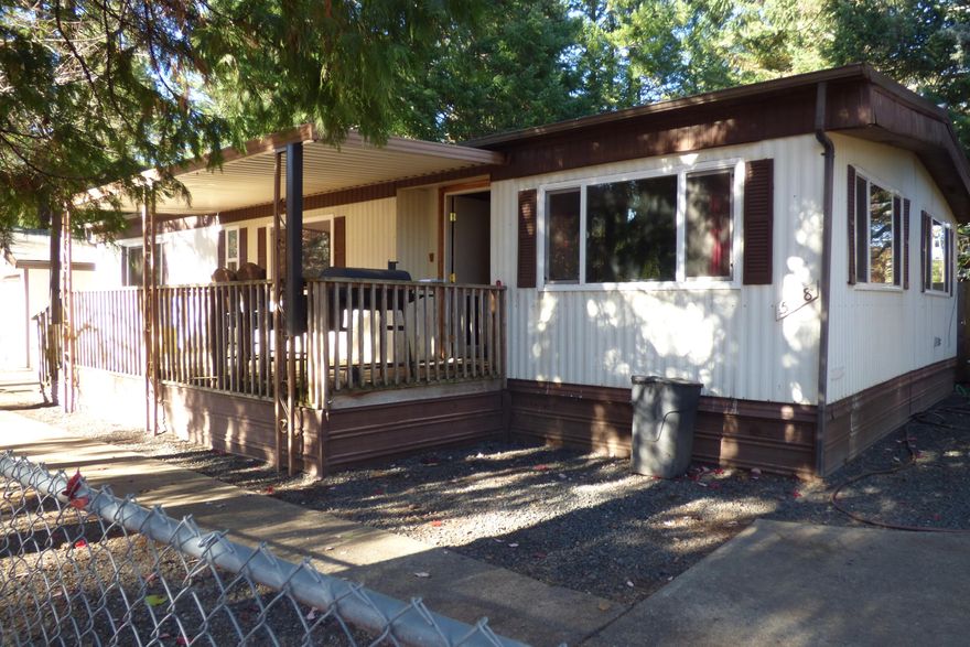 Financiable and priced to sell! This comfortable corner-lot home offers a fully fenced yard on a quiet street, just a short walk from both the high school and middle school. Inside, you'll find three bedrooms, two full bathrooms, easy, functional floor plan, and updated/vinyl frame windows. Enjoy a covered front deck and a one-car detached garage with additional workshop space. (Garage is currently divided into rooms but can be easily converted back.)