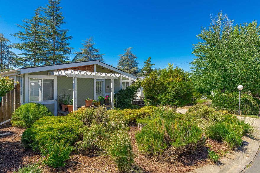 MOTIVATED Seller!  Welcome to this beautiful, spacious home in Ashland's Tolman Creek, All-ages Park.  Located near shopping, restaurants and fitness, it is situated in a quiet Park that offers peace and tranquility.  Its private backyard abuts pasture land, allowing for views of surrounding mountains, and is outfitted with 2 spacious sheds.  There is plenty of room for outside enjoyment, also with space to grow plants and garden.  The driveway and carport provide more than enough room to park two cars.  Additionally, guest parking is nearby.  Enjoy lots of light, updated flooring in the shared living spaces, as well as an updated kitchen with cement countertops!