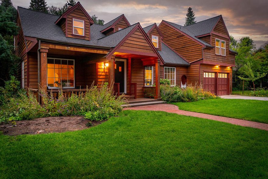 Welcome to this remarkable property that effortlessly combines convenience, charm, and natural beauty. Nestled just moments away from downtown Bend and just one street from the river, this location offers unparalleled convenience while still providing a serene escape along a historic tree-lined street. This character of the home is evident the moment you step onto the inviting front porch, and enter through arched doorways into this light and bright home. The main level includes a living room w/ wood burning fireplace, formal dining room, endearing kitchen with large butcher block island plus guest room and bath. With an oversized primary suite, 2 additional guest bedrooms connected by a playful loft area and hall bath upstairs, and a basement with bedroom, living space, and workshop downstairs, this home offers tons of flexibility. Unwind and relax on your oversized deck and patio and enjoy the lush and beautifully landscaped backyard. Come experience Bend living at its finest.