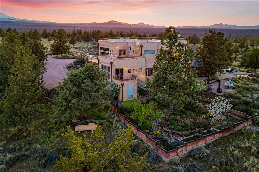 Breathtaking Cascade Mountain Views & Sustainable Living in Tumalo! Immerse yourself in the beauty of this rare 13.2-acre sustainable Tumalo retreat. With both artistry and functionality in mind, the home features abundant natural light, custom woodwork, unique architectural details and panoramic views in every direction. The original log cabin has been seamlessly integrated with a newer addition, creating a perfect fusion of rustic charm & contemporary efficiency. Equipped with solar panels, radiant heated floors, a wood stove, a European boiler, & a backup generator, it delivers a true off-grid experience while maintaining the convenience of on-grid living. Surrounded by BLM land, & part of the wildlife conservation program, this property offers unmatched peace and tranquility. A rare opportunity to own a one-of-a-kind retreat that seamlessly balances nature, sustainability, and modern living.