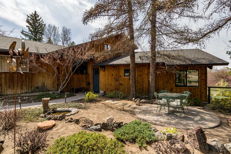 Escape to the tranquility of nature in this beautiful multi-level 3 bedroom, 2.5 bathroom home located in Tumalo, only a mile from downtown. This home is nestled amongst the trees on 1.6 acres of serene surroundings and Mountain views. In it's 1861 square feet of living space it includes two separate living rooms, an updated kitchen & appliances, wood burning fireplace and a new HVAC. There is additional parking/storage available in the detached 2 car garage currently used as a shop. The 1/2 acre of irrigation lends toward low maintenance outside. There is a custom 10'x16' shed in the backyard, Trex decking, new roof in '19 and new windows throughout. Come see this one of a kind home in the most peaceful setting.