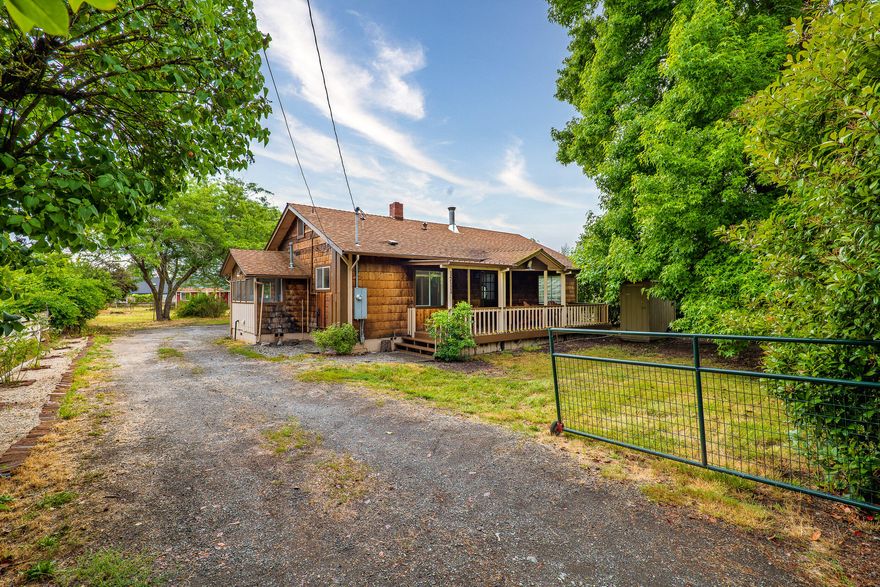 Living is easy in this comfortable residence on a large .55 acre lot! Built in 1920, this 3 bed, 2 bath + bonus room/office home is clean & move-in ready! Bright & open with the original wood floors in the living area and Pergo Flooring in the bedroom and kitchen. Interior is newly painted. The outside has a spacious back yard complete with large shade tree and antique roses perfect for entertaining any time of year!  Ideal for a mini farm with a stall and trough on the back of the out building, that would also make a great art studio.  The floorplan includes a comfortable primary bedroom complete with jack and jill bath with a large jet tub and new sink! Additional features include, fruit trees, attached shop w/ GP Irrigation system.  Plus the whole house is connected to water softener.  You can have all this & be conveniently located close to shopping, restaurants & medical facilities. Call today for your private tour.